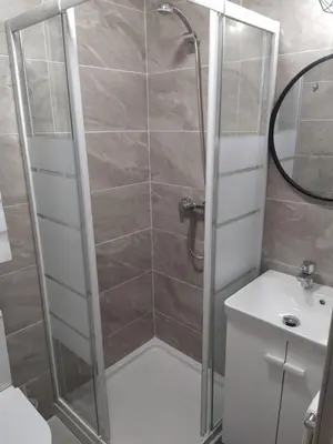 a bathroom with a shower and a toilet and a sink at Villa Romadian in Chiclana de la Frontera