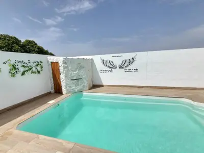 a small swimming pool on the side of a building at Villa Romadian in Chiclana de la Frontera