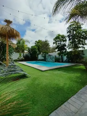 a yard with a swimming pool and grass at Angkor Wat Village in Puerto Real