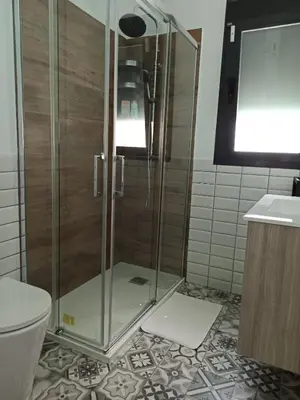 a shower with a glass door in a bathroom at Angkor Wat Village in Puerto Real