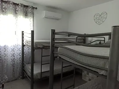 a group of bunk beds in a room with a window at Angkor Wat Village in Puerto Real