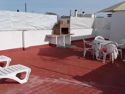 a living room with a table and a tv on a wall at Casasjerezanas Valerian in Jerez de la Frontera