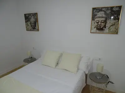 a white couch in a room with two pictures on the wall at Casasjerezanas Valerian in Jerez de la Frontera