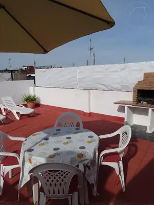 a bedroom with two beds and a small table at Casasjerezanas Valerian in Jerez de la Frontera