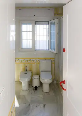 a bathroom with a toilet and a sink at Ático con terraza Centro Ciudad in El Puerto de Santa María