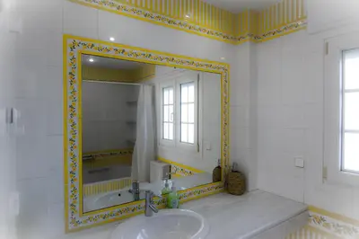 a bathroom with a sink and a mirror at Ático con terraza Centro Ciudad in El Puerto de Santa María