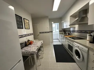 a kitchen with a sink and a table in it at BASTINAZO ALOHADREAM - PREMIUM - La mejor ubicación con Aire Acondicionado, Insonorización, Terraza y Equipamiento en El Puerto de Santa María - Grupo de solo menores de 25 no aceptados salvo fianza adicional in El Puerto de Santa María