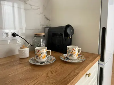 two coffee mugs on a wooden counter in a kitchen at Azvalia - Puro Puerto Casco Histórico in El Puerto de Santa María