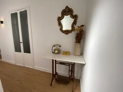 a table in a room with a mirror on the wall at Azvalia - Puro Puerto Casco Histórico in El Puerto de Santa María
