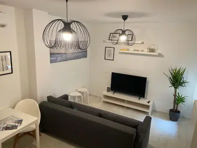 a living room with a couch and a flat screen tv at Hercules in Cádiz
