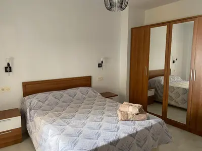 a bedroom with a large bed and a mirror at Hercules in Cádiz