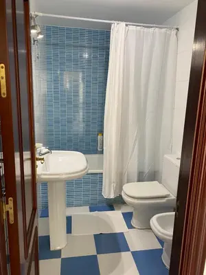a bathroom with a sink and a toilet and a shower at Hercules in Cádiz