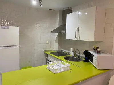 a kitchen with a green counter top with a sink at Hercules in Cádiz