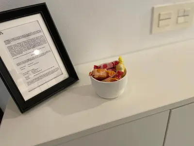 a bowl of fruit sitting on a counter next to a picture at Hercules in Cádiz