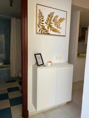 a white cabinet in a room with a picture on the wall at Hercules in Cádiz