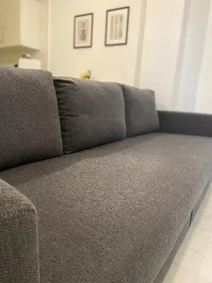 a gray couch sitting in a living room at Hercules in Cádiz