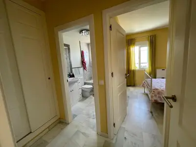 a bathroom with a toilet and a sink at Hochwertiges Haus in wunderschöner Golf Anlage am Meer in Rota