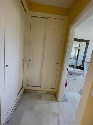 a bathroom with white doors and a sink at Hochwertiges Haus in wunderschöner Golf Anlage am Meer in Rota