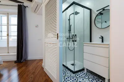 a bathroom with a glass shower stall and a sink at Apartamento San Agustín Feel Cádiz in Cádiz