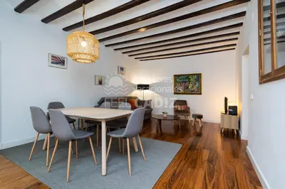 a dining room and living room with a table and chairs at Apartamento San Agustín Feel Cádiz in Cádiz