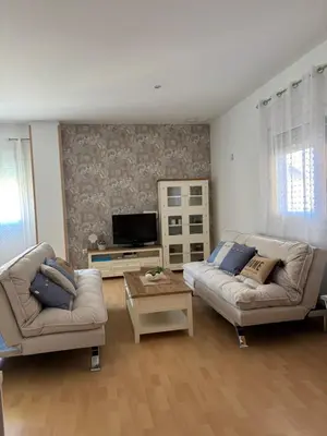 a living room with two couches and a tv at El Mirador de Inés - Primera Línea de Playa in El Puerto de Santa María