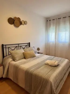 a bedroom with a large bed with a white blanket at El Mirador de Inés - Primera Línea de Playa in El Puerto de Santa María