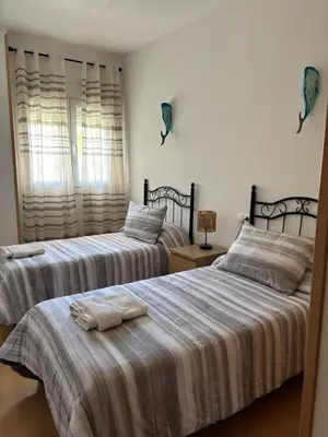 two beds sitting next to each other in a bedroom at El Mirador de Inés - Primera Línea de Playa in El Puerto de Santa María