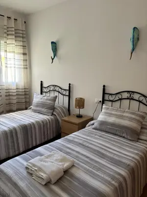 two beds sitting next to each other in a bedroom at El Mirador de Inés - Primera Línea de Playa in El Puerto de Santa María