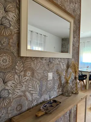 a mirror on a wall above a wooden table at El Mirador de Inés - Primera Línea de Playa in El Puerto de Santa María