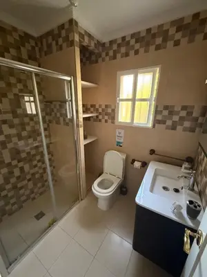 a bathroom with a toilet and a shower and a sink at Chalet en La Barrosa, Piscina+BBQ+Grifo de Cerveza in Chiclana de la Frontera