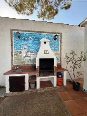a play kitchen in front of a wall with a mural at Chalet en La Barrosa, Piscina+BBQ+Grifo de Cerveza in Chiclana de la Frontera