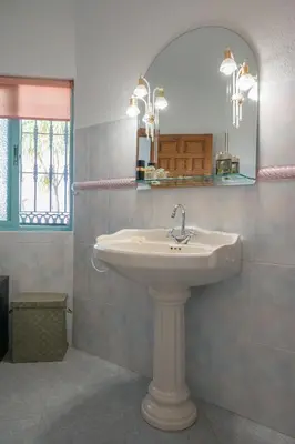 a bathroom with a sink and a mirror at Villa La Contenta jardín y piscina en Conil centro in Conil de la Frontera