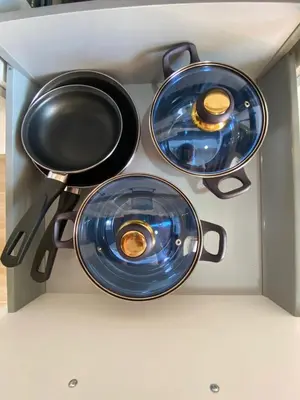 three pots and pans sitting on top of a stove at LA VENDIMIA in Jerez de la Frontera