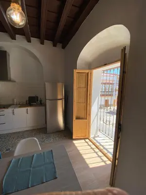 a kitchen with an open door and a refrigerator at LA VENDIMIA in Jerez de la Frontera