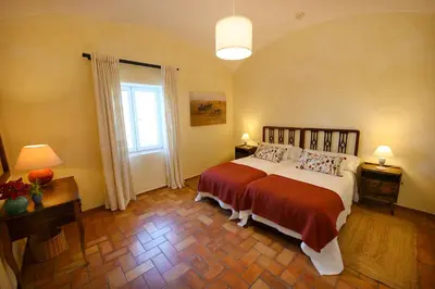 a bedroom with a large bed and a window at Cortijo de Guerra in Puerto Real