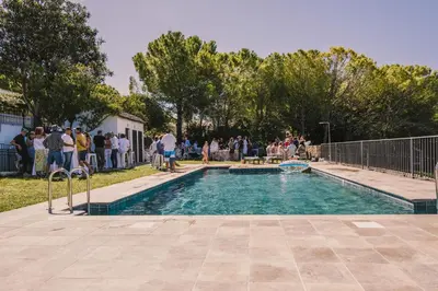 a group of people standing around a swimming pool at Cortijo de Guerra in Puerto Real
