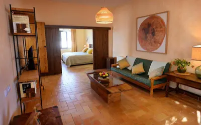 a living room with a couch and a bed at Cortijo de Guerra in Puerto Real