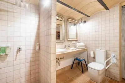 a bathroom with a toilet and a sink at LalaSuites SHARIS in Jerez de la Frontera