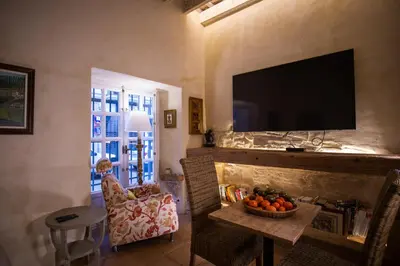 a living room with a fireplace with a flat screen tv at LalaSuites SHARIS in Jerez de la Frontera