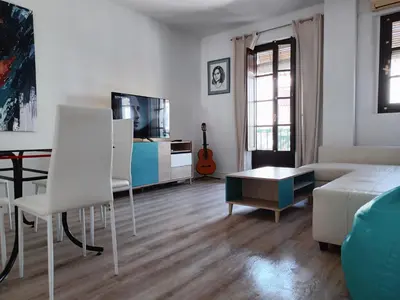 a living room with a couch and a table at Apartamento Luz de Sanlúcar in Sanlúcar de Barrameda