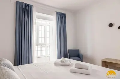 a bedroom with a bed with two towels on it at La Luz de la Viña - by Cadiz Time in Cádiz