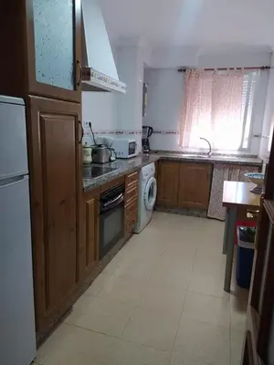 a kitchen with a sink and a stove top oven at Apartamento grumete in El Puerto de Santa María