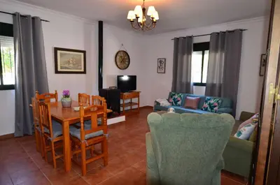 a living room with a table and chairs at Chalet Roche (Conil) | Alquileres Atardecer in Roche