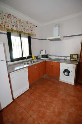 a kitchen with a sink and a washing machine at Chalet Roche (Conil) | Alquileres Atardecer in Roche