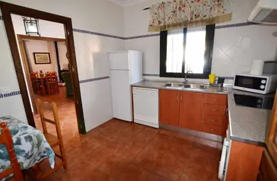 a kitchen with a white refrigerator and a sink at Chalet Roche (Conil) | Alquileres Atardecer in Roche