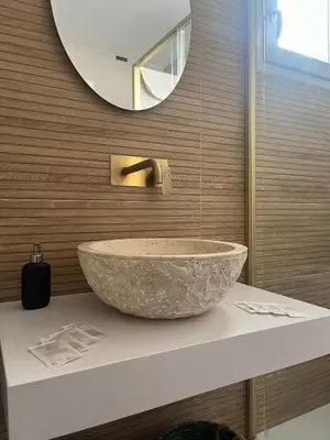 a bathroom with a large stone sink on a counter at Hidden Gem Penthouse El Mesón in Cádiz