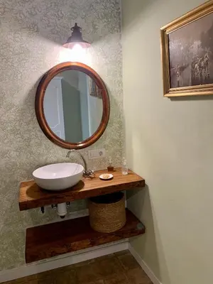 a bathroom with a sink and a mirror at Patios del Agua in El Puerto de Santa María