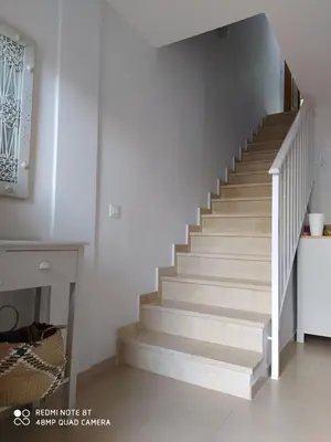 a staircase in a home with white walls and white floors at Casa playa Bajo de Guía-Centro in Sanlúcar de Barrameda