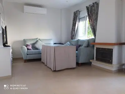 a living room with a couch and a table at Casa playa Bajo de Guía-Centro in Sanlúcar de Barrameda