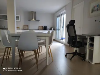 a kitchen and dining room with a table and chairs at Casa playa Bajo de Guía-Centro in Sanlúcar de Barrameda